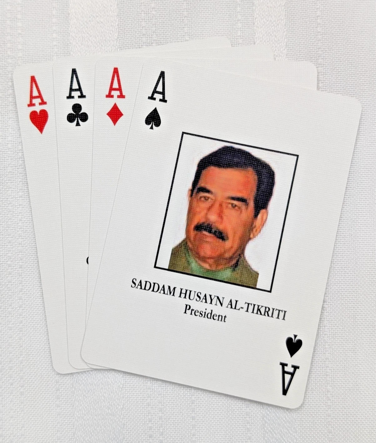 Four Aces fanned with Ace of Spades Saddam Hussein prominent
